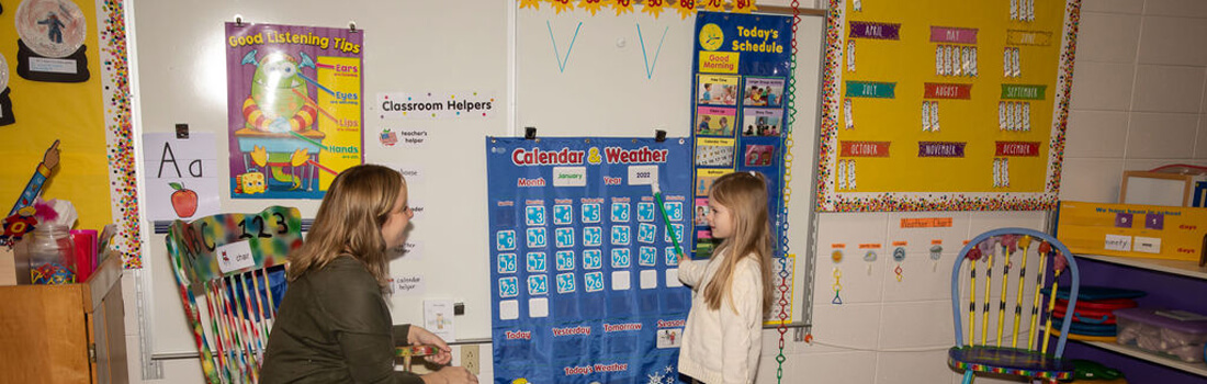 Student demonstrating a knowledge of weather to their teacher