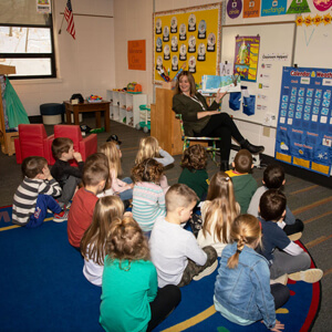 A teacher giving a lesson to her young students