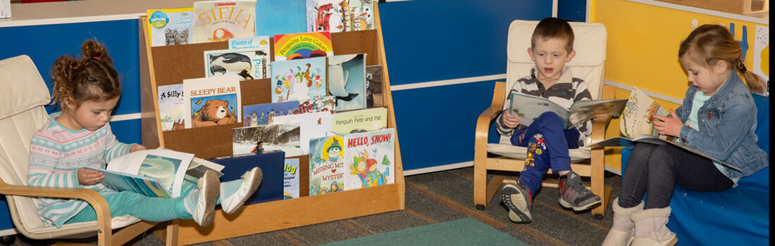 Children sitting reading quietly